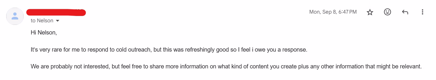 Screenshot of a short email reply declining interest in a sales conversation while complimenting the quality of the cold outreach and inviting additional information about content offerings.